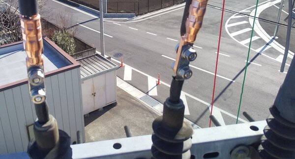 高所作業車から見た電柱上の接続部。電線の端に圧縮端子を取り付け、ボルトで接続している